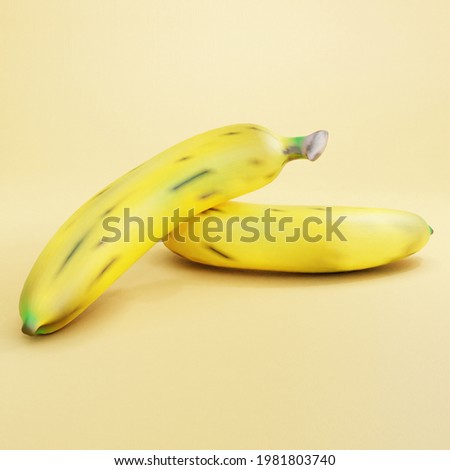 2 tropical yellow bananas on yellow background. Smooth bananas photo