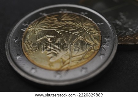 2 two euro coin issued in Italy close up. Dark money background or wallpaper. European Union currency and ECB. Eurozone economy news. Bank and finance. Macro