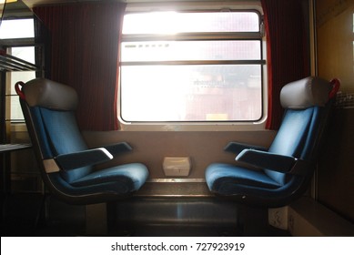 2 Vintage Train Chairs Facing Each Other With Window