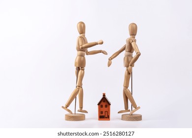 2 wooden mannequins depicting a couple arguing about a house, isolated on white background. Copy space. Concept of housing, couple and conflict - Powered by Shutterstock