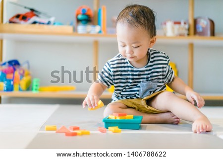 2 years baby boy.Little child boy playing with Shape Creative Puzzle toys block with mother.Kids play with educational toys at home.Day care and Kindergarten school.child development concept.