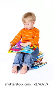 2 years old baby boy reading pop-up books.