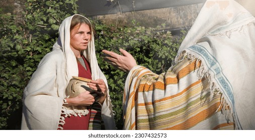 2 young human faith Lord hand ask god drink offer help jew maid slave look stare gossip hold old retro jar vase arab shawl cloth. Bless joy hope israeli rural lady chat preach face farm yard hous home - Shutterstock ID 2307432573