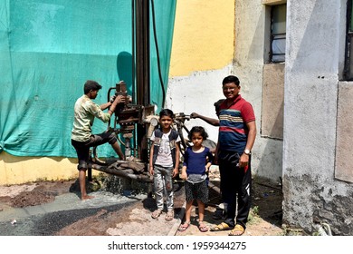 20 April 2021, Aurangabad, Maharashtra, India.  Indian Family Is Happy By Looking Artesian Water During Summer Season At His Home. Indian Family With Ground Water Well Drilling Equipment Behind Them.