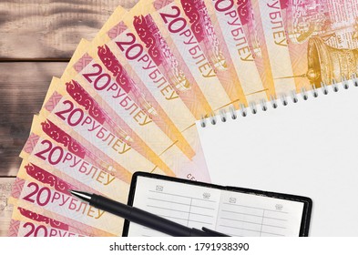20 Belorussian rubles bills fan and notepad with contact book and black pen. Concept of financial planning and business strategy - Shutterstock ID 1791938390