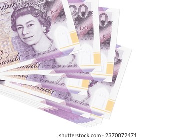 20 British pounds bills lies in small bunch or pack isolated on white. Mockup with copy space. Business and currency exchange concept