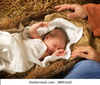 20 days old baby sleeping in a christmas nativity crib
