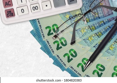 20 euro bills fan and calculator with glasses and pen. Business loan or tax payment season concept