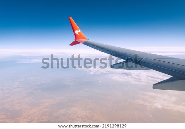 20 July\
2022, Antalya, Turkey: Corendon airline logo on a winglet. Airplane\
wing view from the window during a flight on vacation. Beautiful\
sky and curved winglet for fuel\
economy