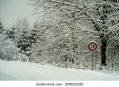 20 km h speed limit roadsign in snowy road. Winter landscape. High quality photo