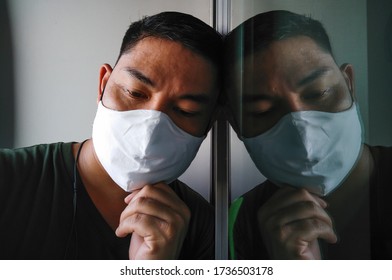 20 May 2020 Bangkok,Thailand,
Sad Man Wearing Protective Masks, Covid 19,Looking Out Window, The Period Of Detention At Home,Thailand Controls The Spread Of Coronavirus, 