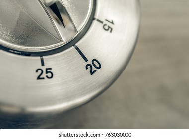 20 Minutes - Macro Of An Analog Chrome Kitchen Timer On Wooden Table