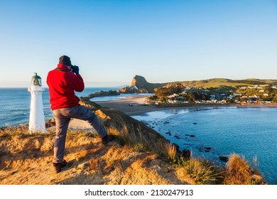 20 November 2012: Castlepoint, New Zealand - Photographer at Castlepoint Lighthouse, Wairarapa, New Zealand.