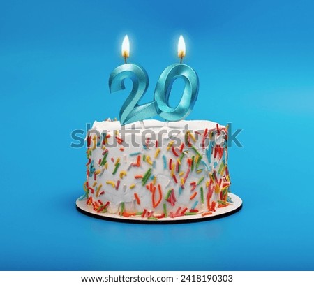 20 shaped candle light on happy birthday cake on blue