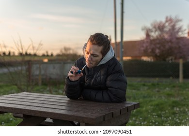 A 20 Something Male Smoking A Cannabis Joint To Help With His Health. Alternative Medicine, Medical Marijuana Concept