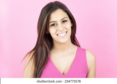 A 20 Years Old Woman In Front Of A Pink Background.