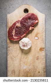 A 200 Gram Entrecote Piece Of Beef On A Cutting Board In A Kitchen.