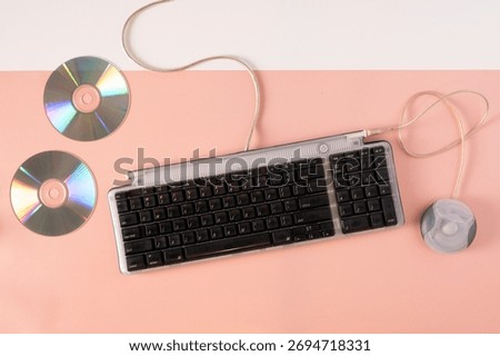 2000s Computer Era Setup with Wired Keyboard and CD disc