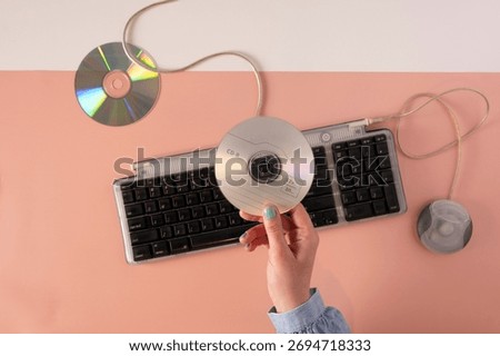 2000s Computer Era Setup with Wired Keyboard and CD disc
