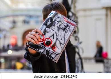 2010.04.03, Moscow, Russia. A Young Man Holding A Magazine In His Outstretched Hand In Front Of Him.