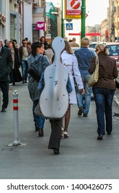 2010.04.11, Moscow, Russia. A Girl Musician Carries A Cello In A Case On The Back.