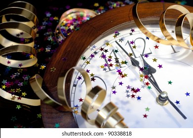 2012 New Years Party Background. Clock And Festive Tinsels