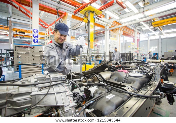 2012, Vladivostok - Automotive Plant.
Disassembled cars are in a large bright
workshop.