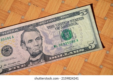 2013 Series 5 US Dollar Note. Portrait Of Abe Lincoln On Table.