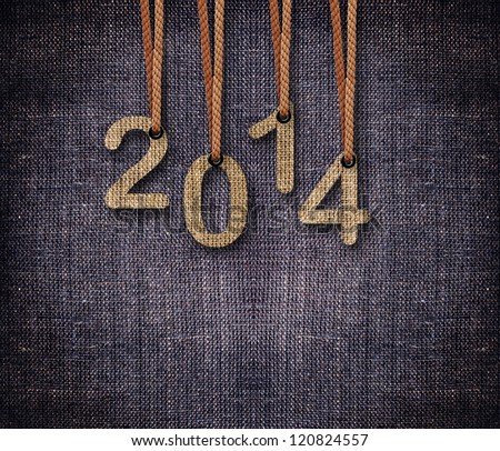 2014 numbers hanging by rope as puppeteer on sackcloth background.