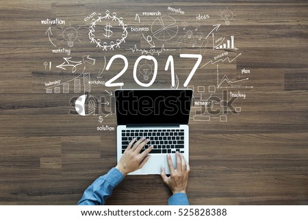 2017 new year business success, Creative thinking drawing charts and graphs strategy plan ideas wooden table background, Inspiration concept with businessman working on laptop computer PC, Top View