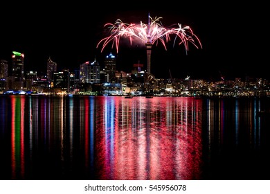 2017 New Years Eve Fireworks In Auckland New Zealand Over The Iconic Famous Sky Tower And Downtown City Reflected In Water For The First Display In The World