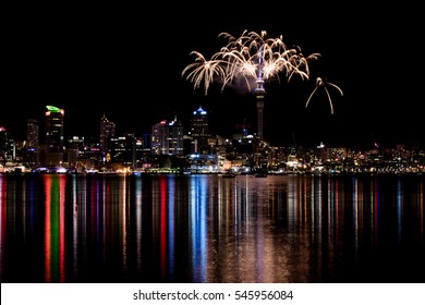 2017 New Years Eve Fireworks In Auckland New Zealand Over The Iconic Famous Sky Tower And Downtown City Reflected In Water For The First Display In The World