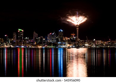 2017 New Years Eve Fireworks In Auckland New Zealand Over The Iconic Famous Sky Tower And Downtown City Reflected In Water For The First Display In The World