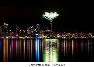 2017 New Years Eve Fireworks In Auckland New Zealand Over The Iconic Famous Sky Tower And Downtown City Reflected In Water For The First Display In The World