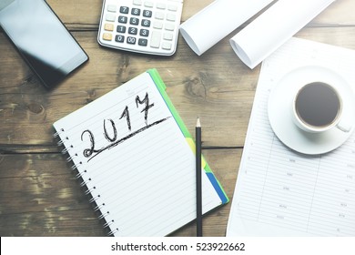 2017 text on notebook and coffee,calculator,pone and papers on table - Powered by Shutterstock