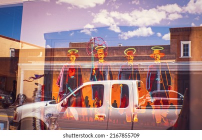 2017_07_19_Santa Fe USA - Reflections in shop window in Santa Fe New Mexico showing neon sign and truck and Native America Artifacts and reflected buildings