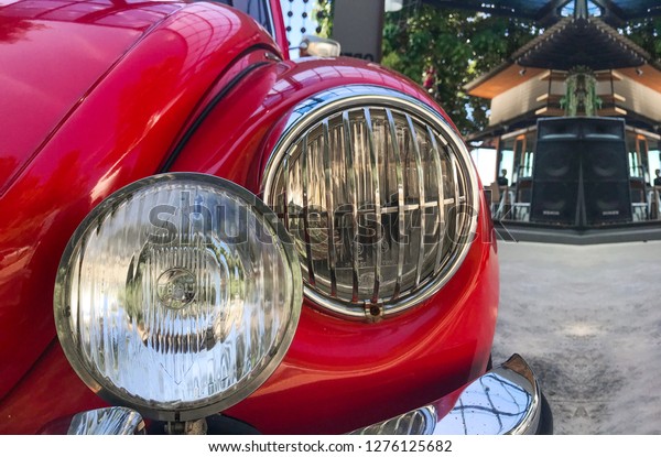 2018\
December 27. Phuket Thailand. front White light part of parking\
vintage red volkswagen beetle at the public\
park.