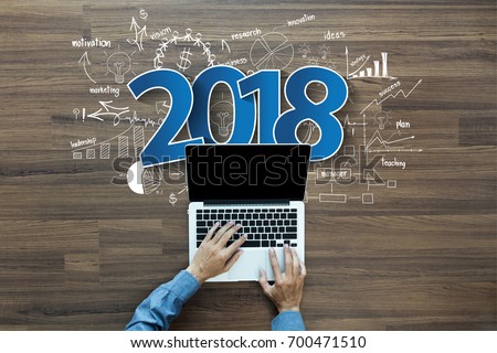 2018 new year business success, Creative thinking drawing charts and graphs strategy plan ideas wooden table background, Inspiration concept with businessman working on laptop computer PC, Top View