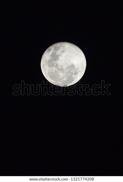 2019 February Full moon\
on the dark south asian sky.Yellow Moon. Red Moon.Moon with cloudy\
night sky.