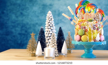 2019 Happy New Year's candy land lollipop drip cake in colourful party table setting.