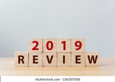 2019 review concept. The word REVIEW on wooden cube block on wood table