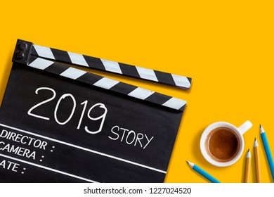 2019 Story ,text Title On Movie Clapper Board And Coffee Cup