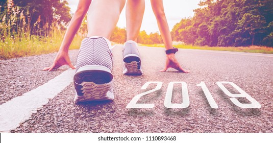 2019 symbolises the start into the new year.Start of people  running on street,with sunset light.Goal of Success - Shutterstock ID 1110893468