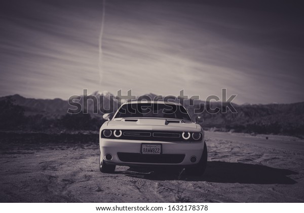 2019 White Dodge Challenger with mountains in
background in black and
white