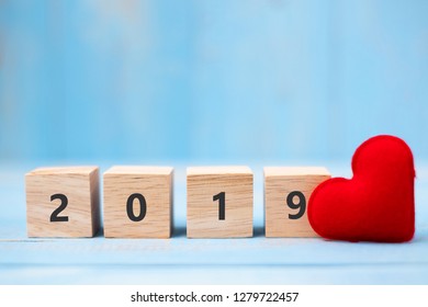 2019 wooden cubes with red heart shape decoration on blue table background and copy space for text. Business, Resolution, New Year New You and Happy Valentine’s day holiday concept