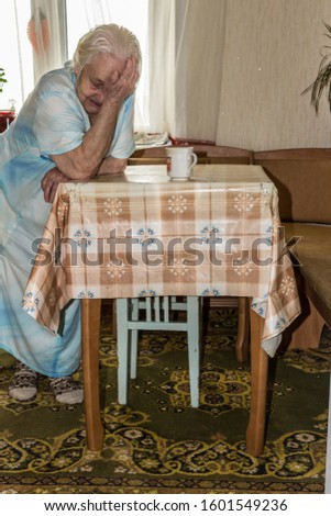 Caregiver making bed of elderly patient in nursing home