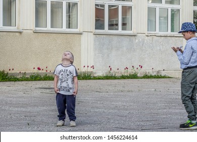 2019.05.22, Maloyaroslavets, Russia. Little boy looking into the sky. A kid looking up.