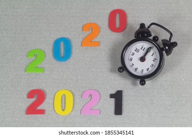 2020, 2021 In Colored Figures And Black Alarm Clock