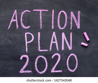 2020 Action Plan. Handwriting Text With Chalk On Black Board, Copy Space