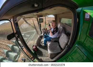 2020 Corn Harvest, Fairmont, Minnesota. USA Woman Midwest Farmer Wanda Patsche Radios Her Husband From The Cab Of A John Deere 5680 Combine During Harvest Operations Of Their Farm. 10-09-20